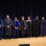 Group of faculty members line up on stage to be honored